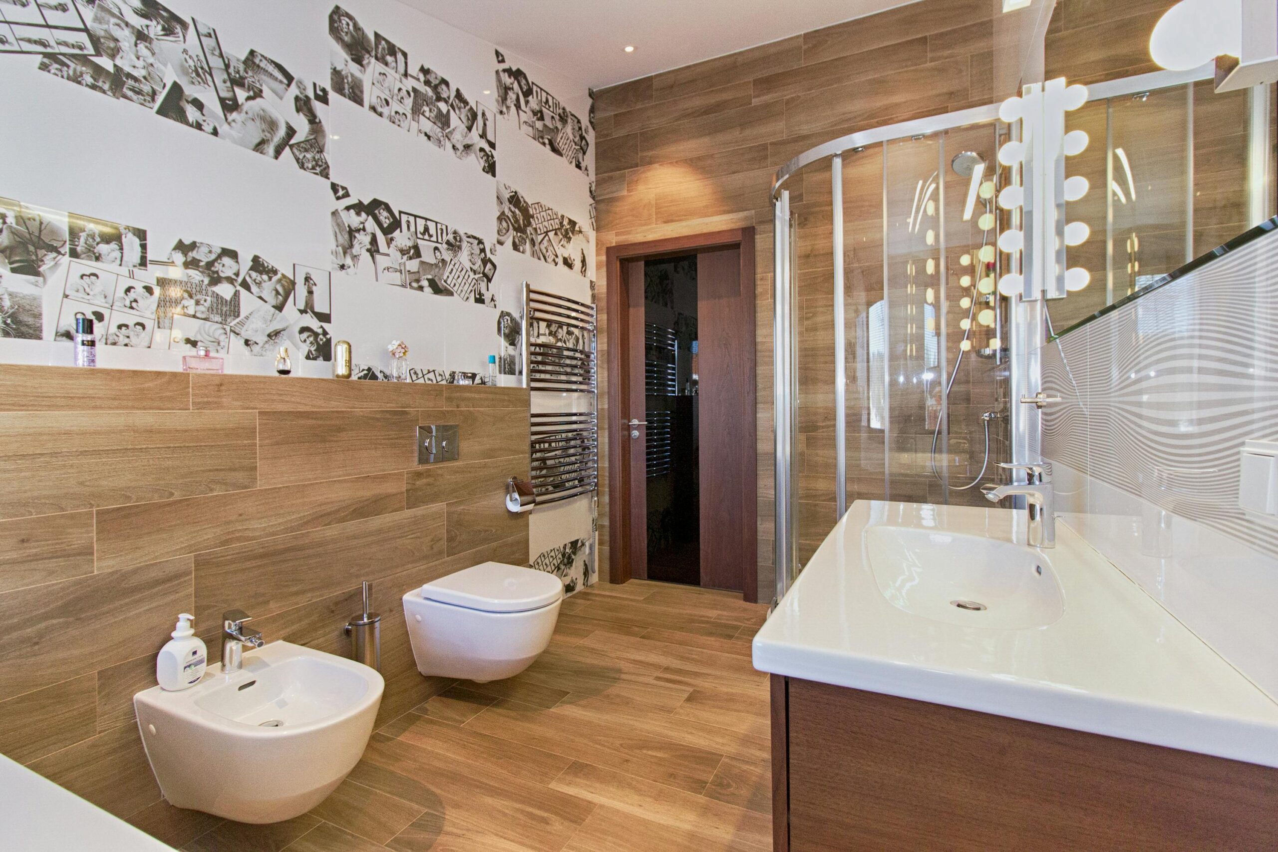 Elegant bathroom featuring wood paneling, modern fixtures, and ample lighting